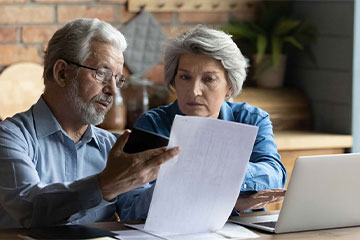an older couple reviewing insurance documents together